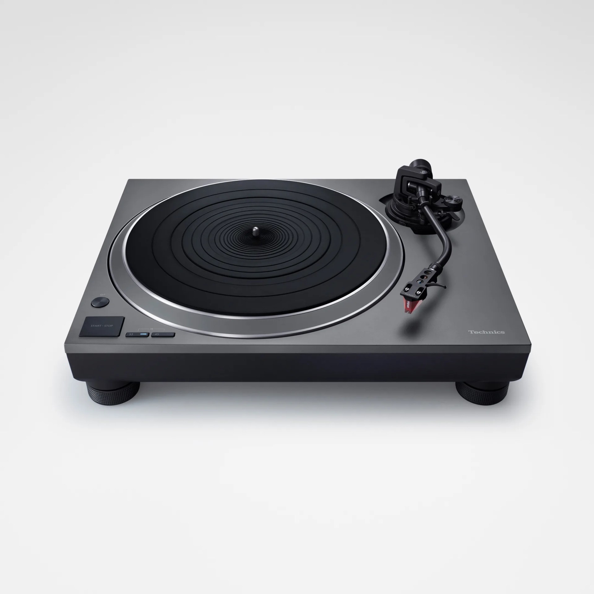 Technics gray and black turntable with tonearm and red cartridge on a white background.