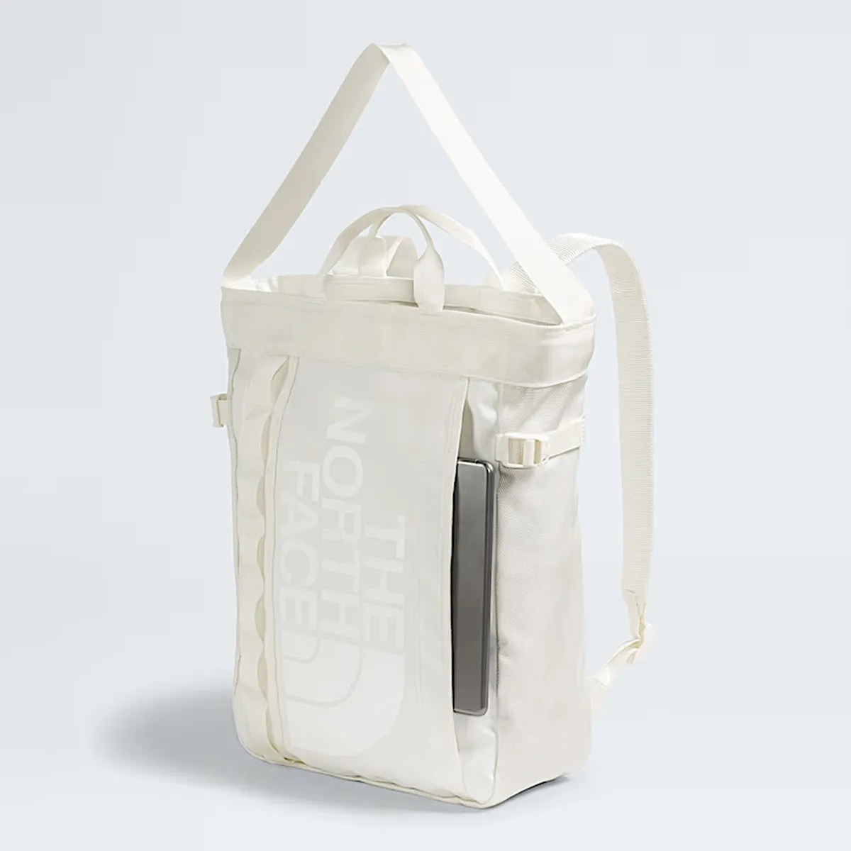 Off-white The North Face backpack with a front pocket holding a laptop.