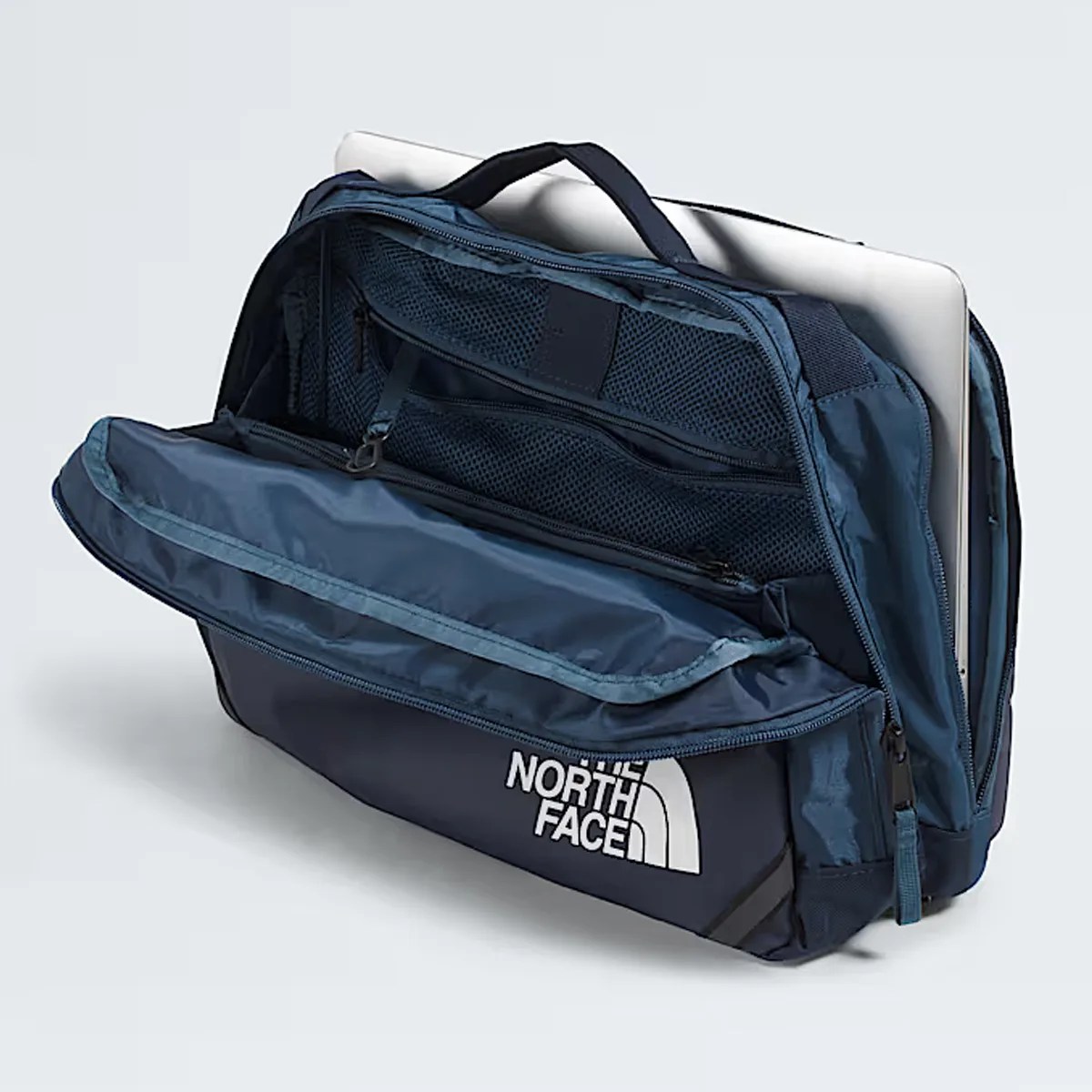 Navy blue North Face laptop bag with open front compartment showing mesh pockets and a laptop inside.