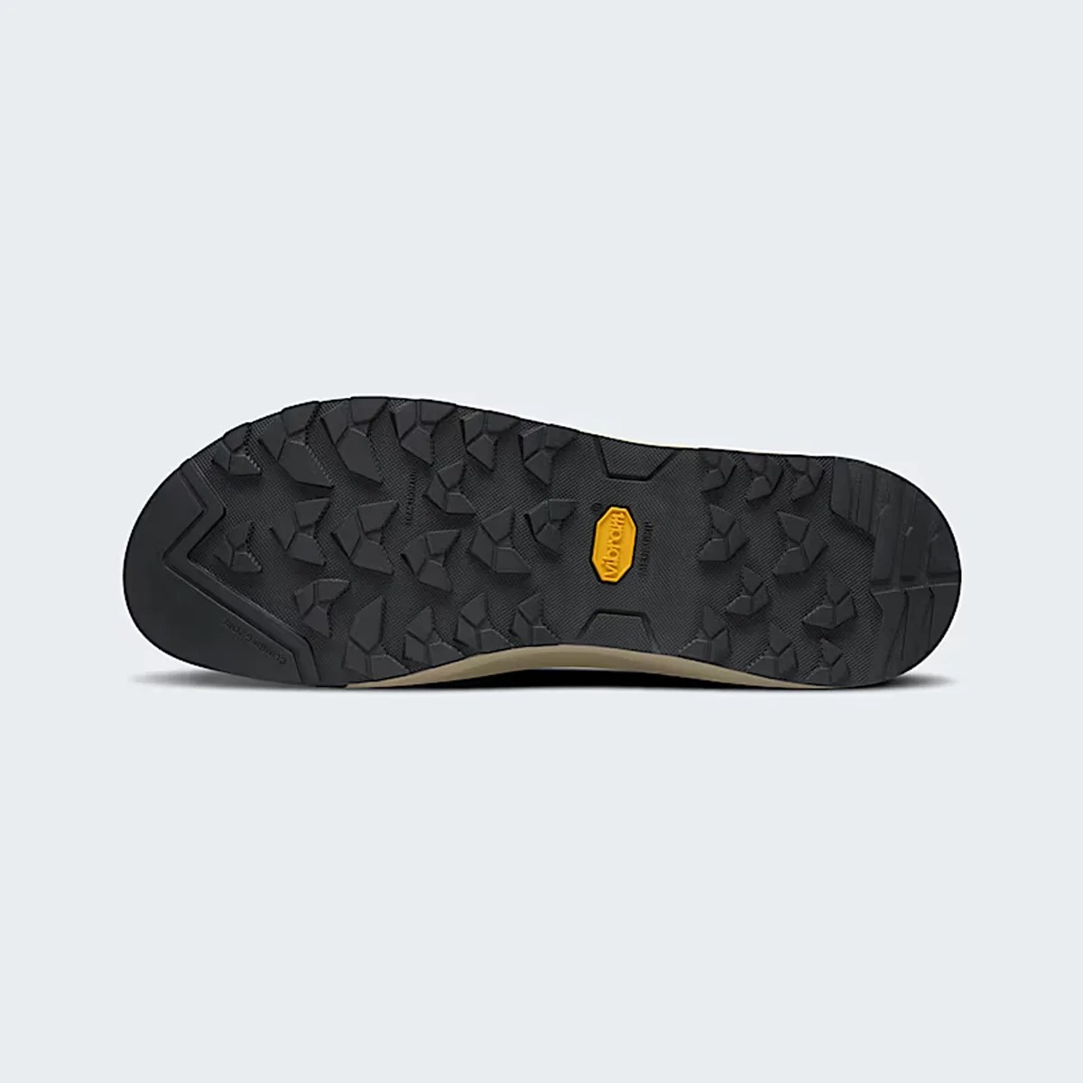 Black Vibram rubber outsole with deep, angular treads and a yellow Vibram logo in the center.