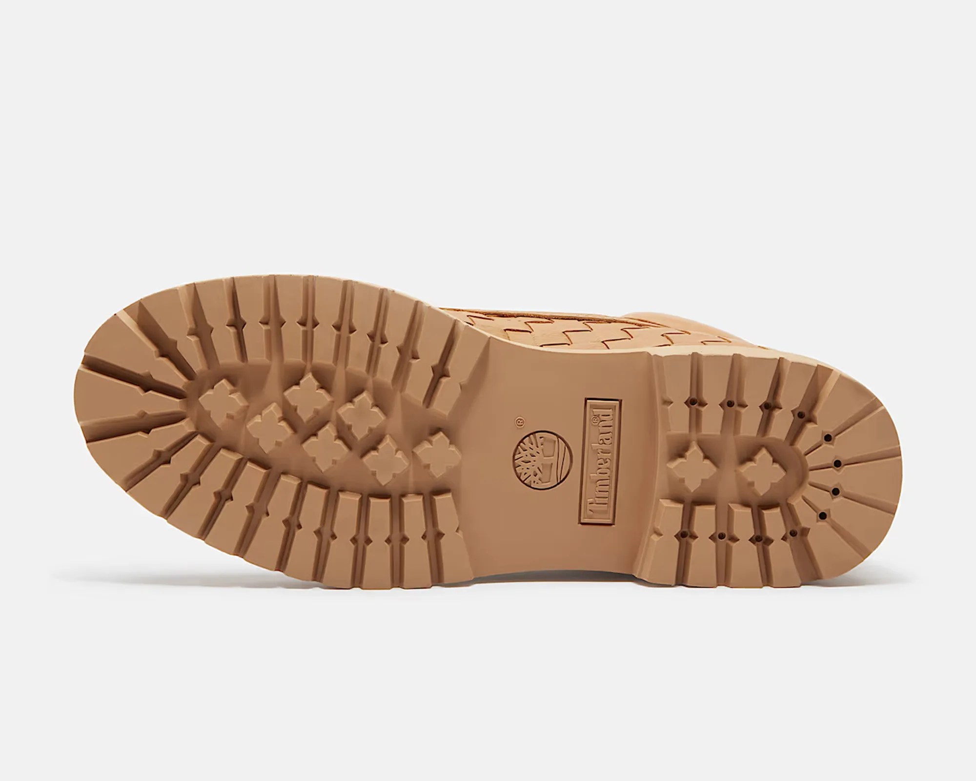 Light brown rubber boot sole with deep treads and Timberland logo embossed in the center.