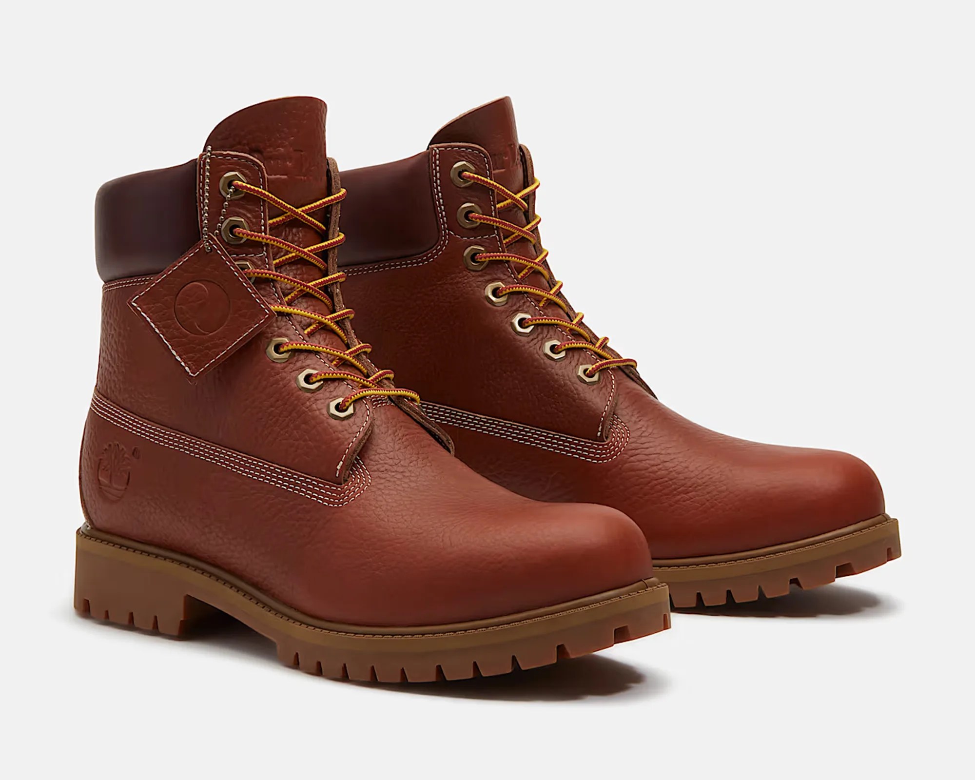 Pair of brown leather lace-up work boots with padded collar and rugged rubber soles.