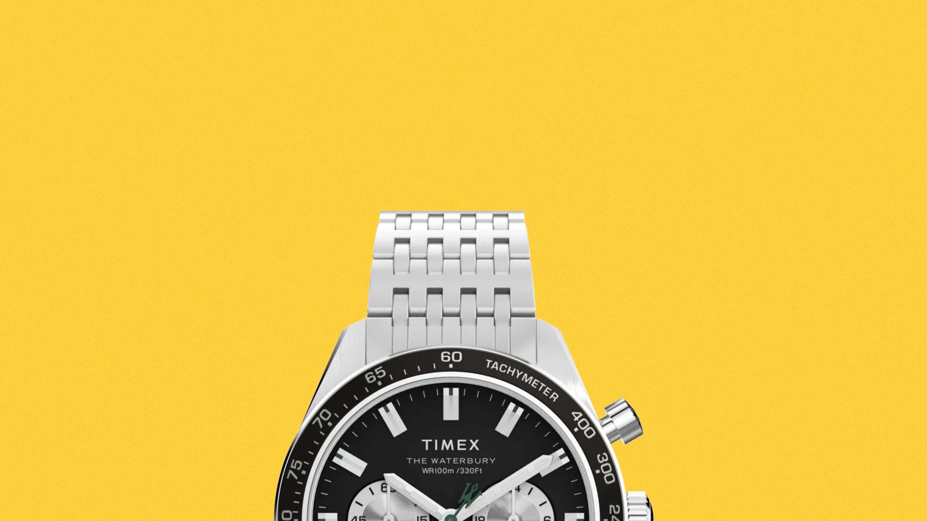 Silver metal Timex Waterbury wristwatch with black dial and tachymeter bezel on a yellow background.