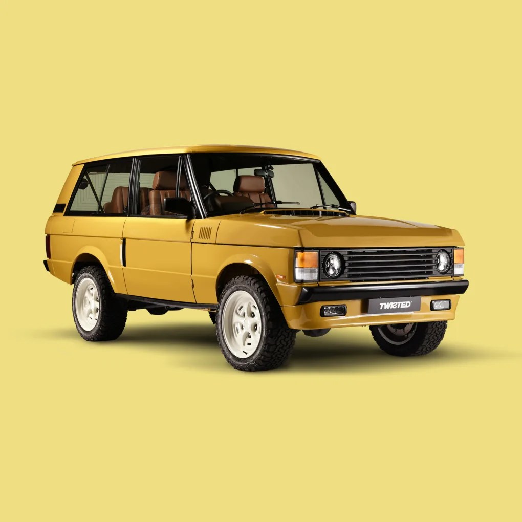 Yellow vintage two-door SUV with white wheels and brown leather interior on a yellow background.