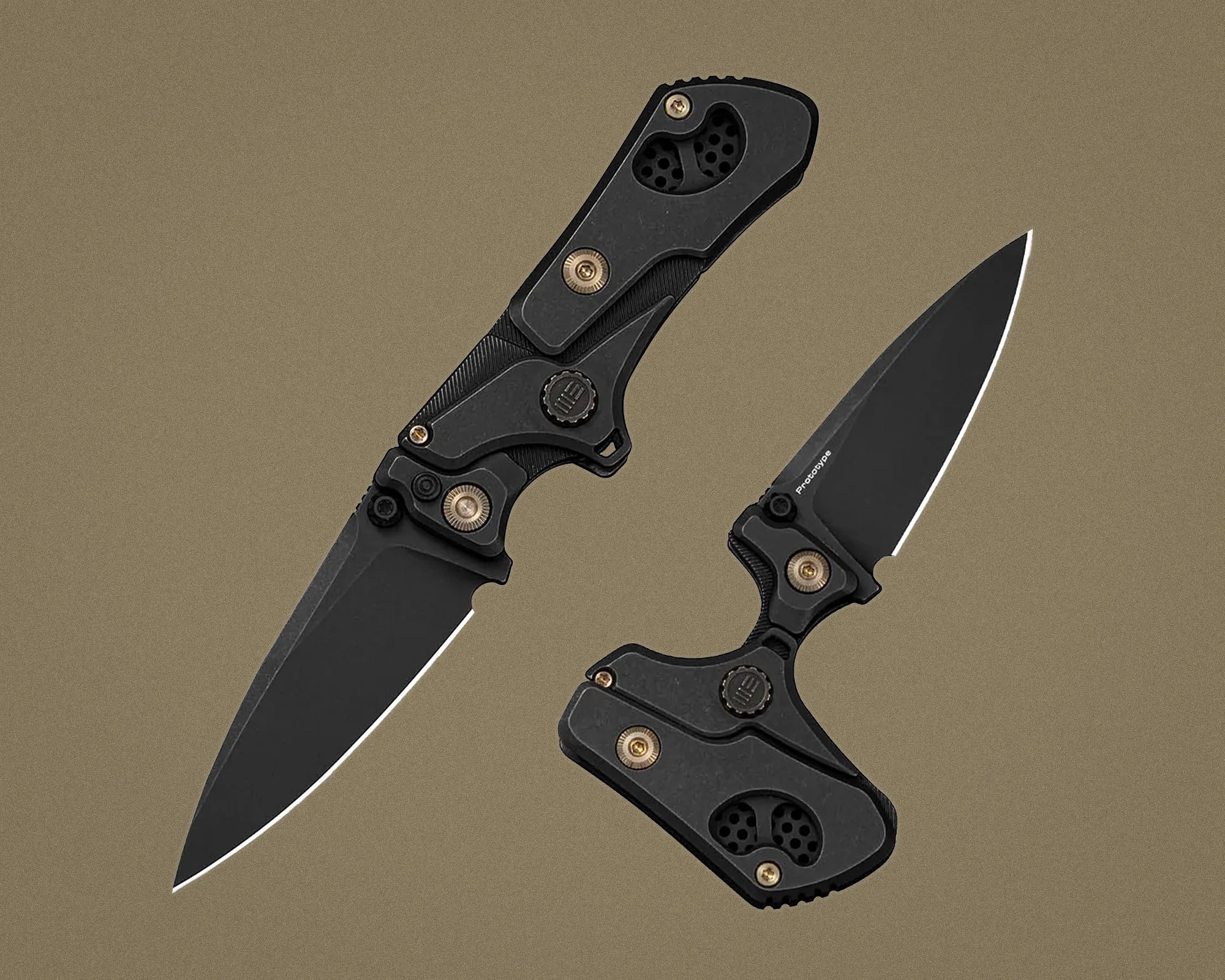 Two black folding knives with brass screws and textured handles on a brown background.