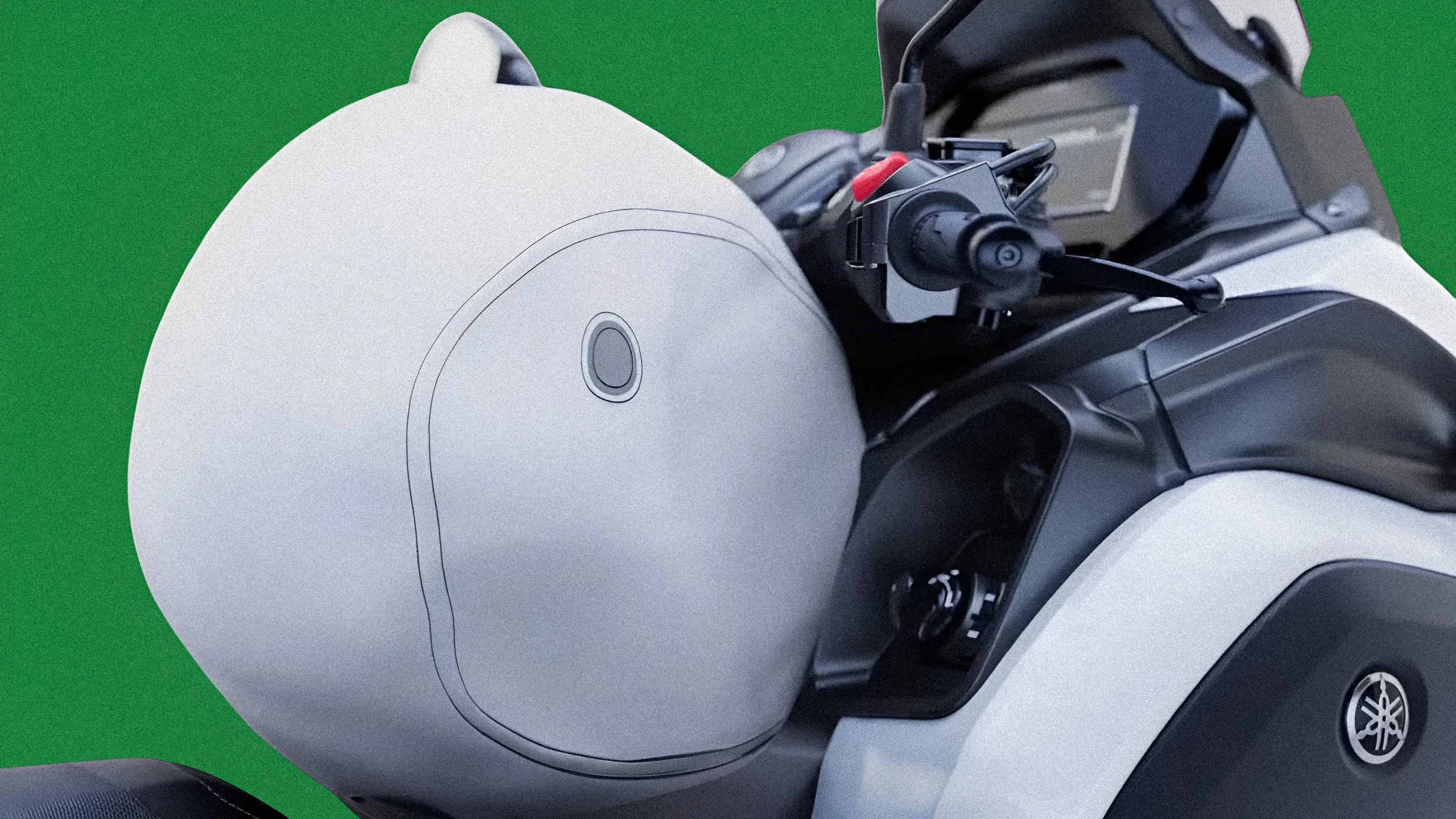 White soft motorcycle saddlebag attached to a black and white Yamaha bike against a green background.