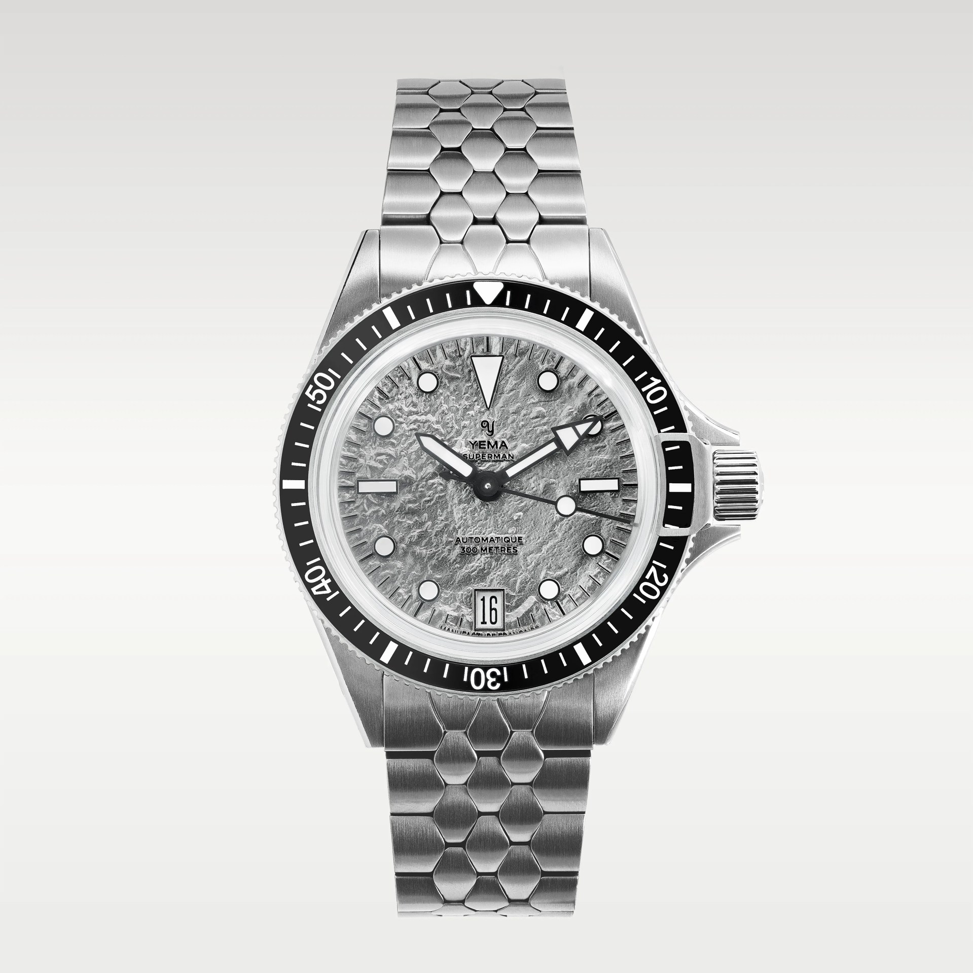 Silver stainless steel Yema Superman watch with textured gray dial and black bezel on a matching metal bracelet.