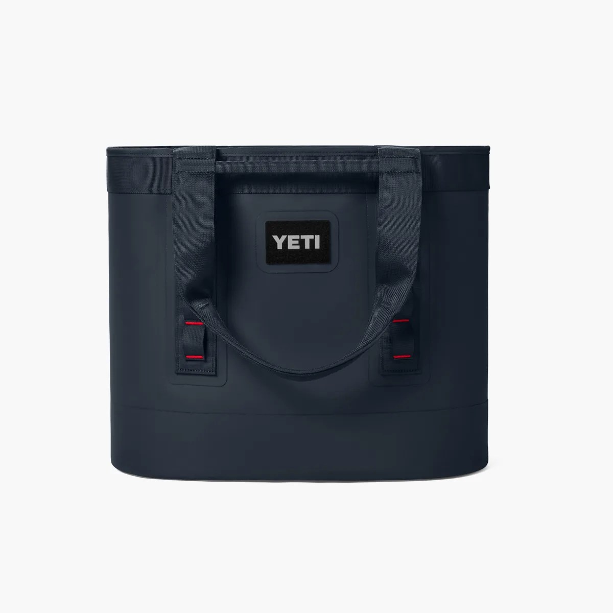 Navy blue YETI soft cooler bag with dual handles and a rectangular shape.