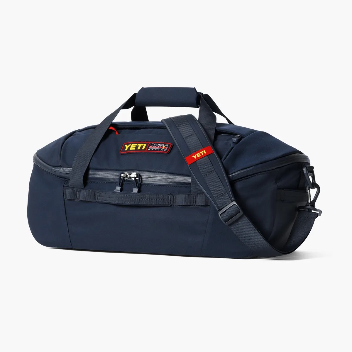 Navy blue YETI duffel bag with black straps and a red YETI logo patch on the front.