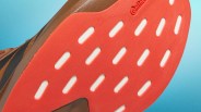 Close-up of a brown shoe sole with red rubber and white cutout sections, featuring the Continental logo.