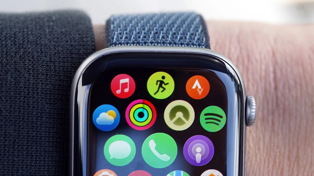 Smartwatch with a blue woven band displaying colorful app icons on the screen, worn on a wrist.