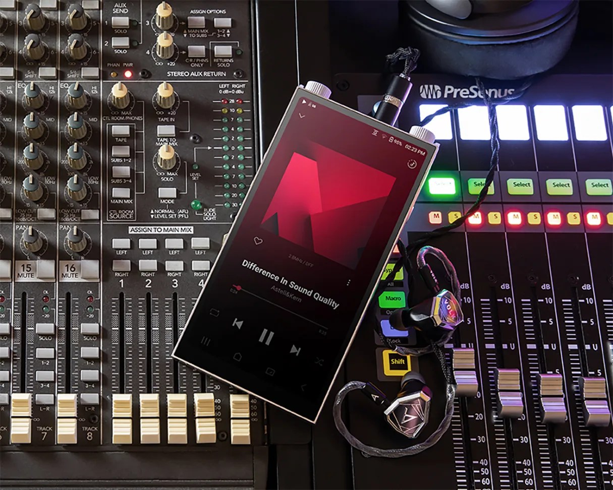 Digital music player displaying "Difference In Sound Quality" by Astell&Kern with connected in-ear monitors on a sound mixing console.