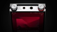 Top view of a digital audio player showing two large silver control knobs, headphone and balanced output jacks, and a screen with music playback interface.