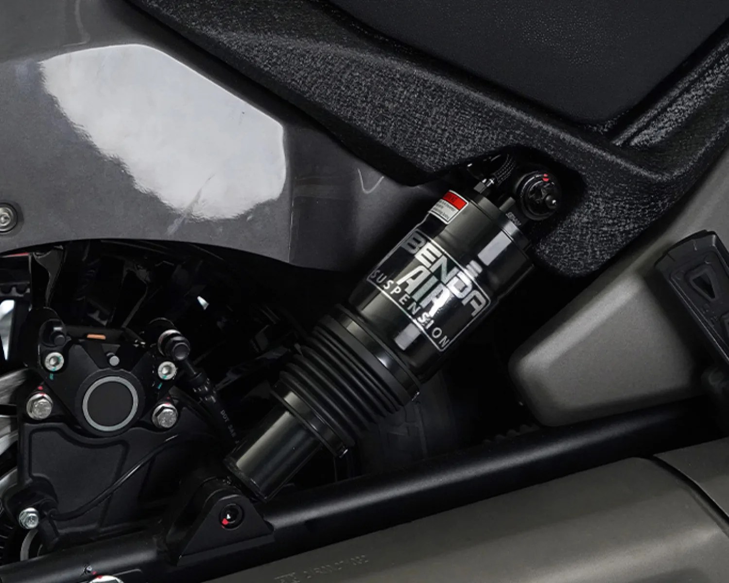 Black Benda Air suspension shock absorber mounted on a motorcycle frame.