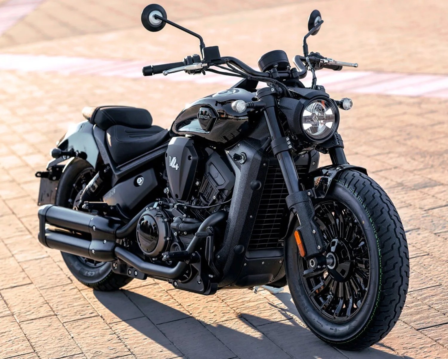 Black cruiser-style motorcycle with V4 engine and dual exhaust pipes parked on a paved surface.
