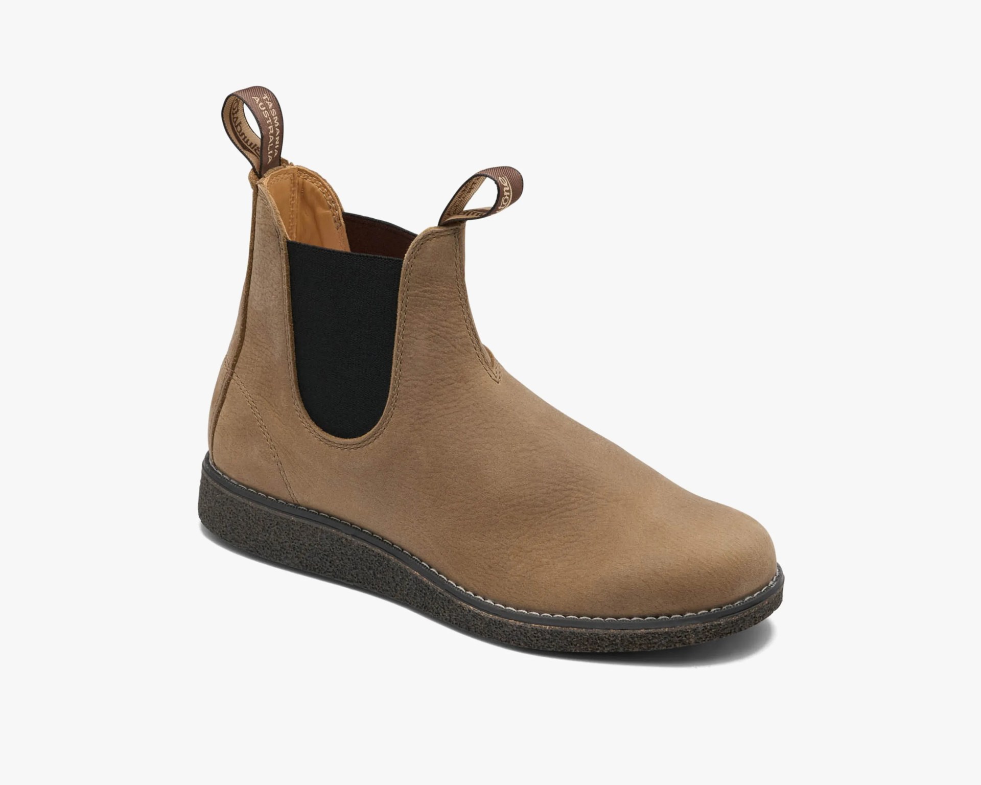 Light brown leather Chelsea boot with black elastic side panels and dark textured sole.