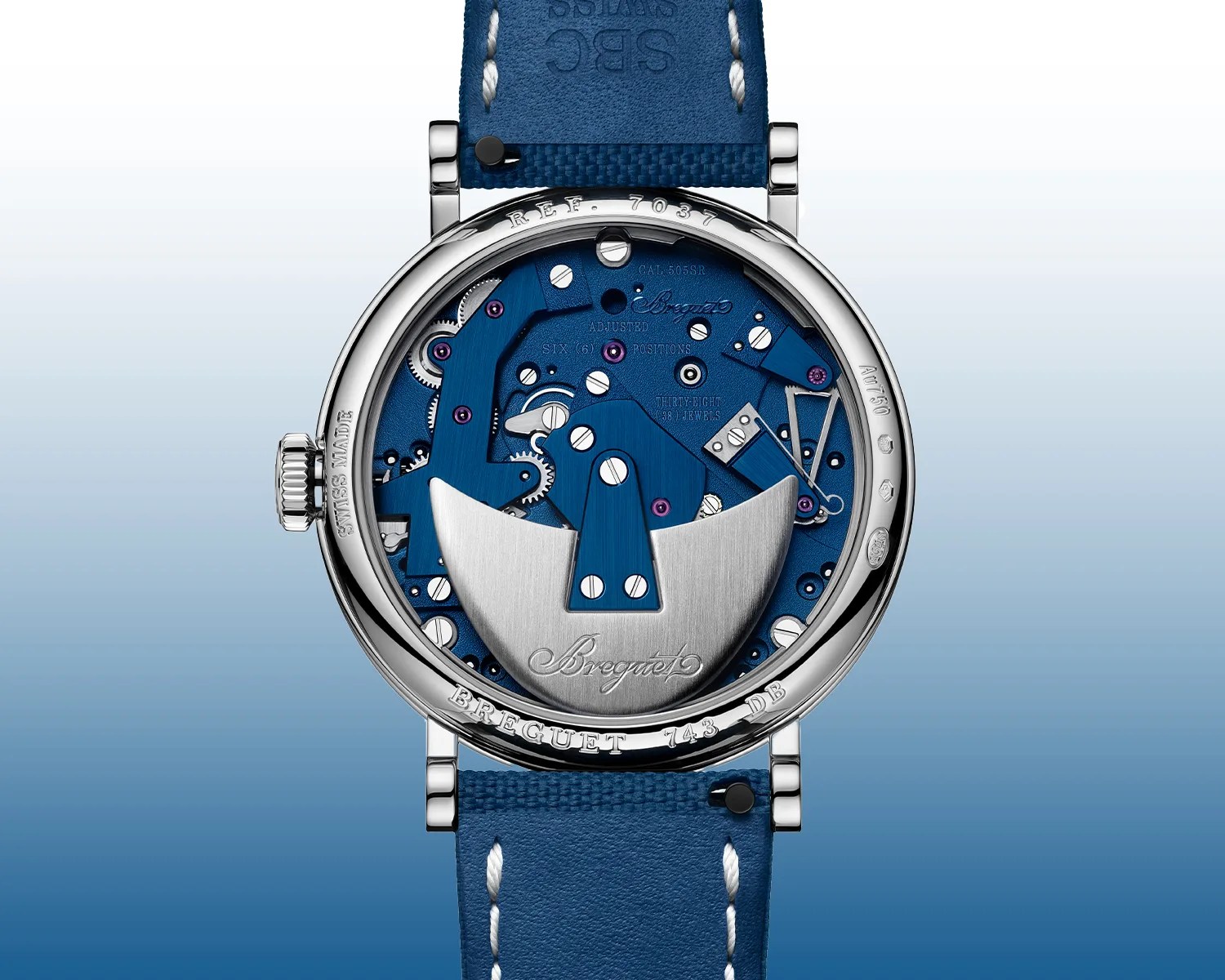 Back view of a Breguet watch showing a blue mechanical movement with silver rotor and blue leather strap.