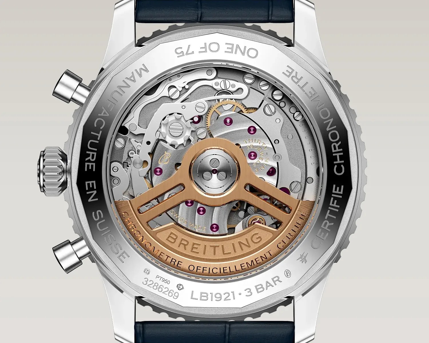 Back view of a Breitling watch showing the intricate mechanical movement with a rose gold rotor and engraved text on the stainless steel case.