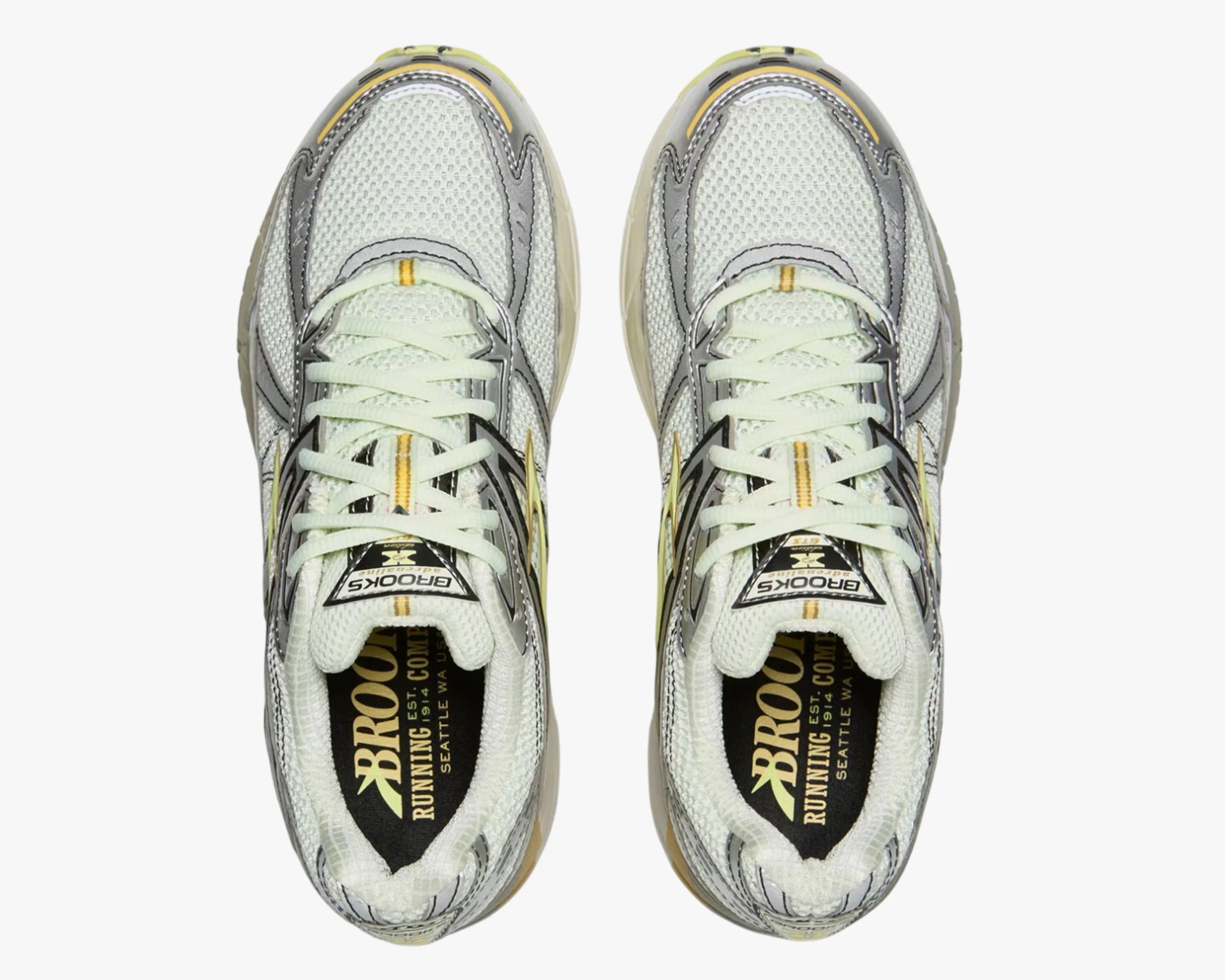 Pair of white and gray Brooks running shoes with yellow accents viewed from above.