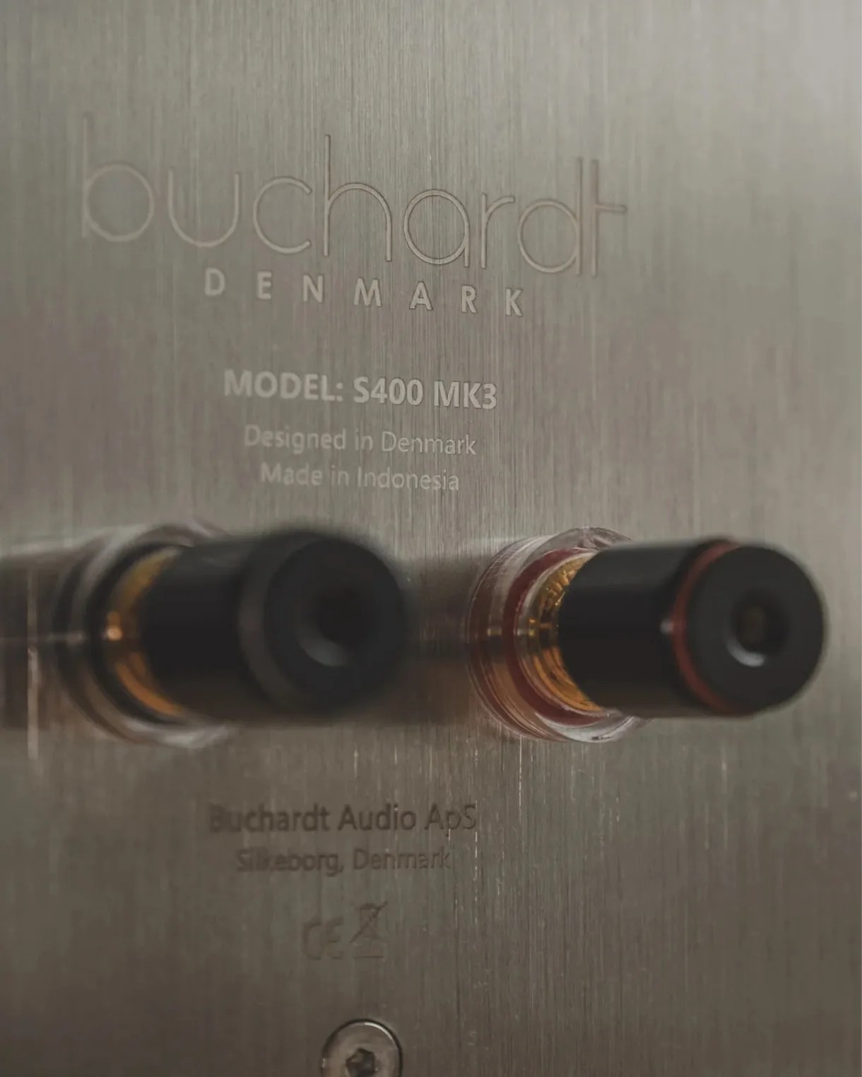 Close-up of Buchardt Audio S400 MK3 speaker terminals on a brushed metal panel.