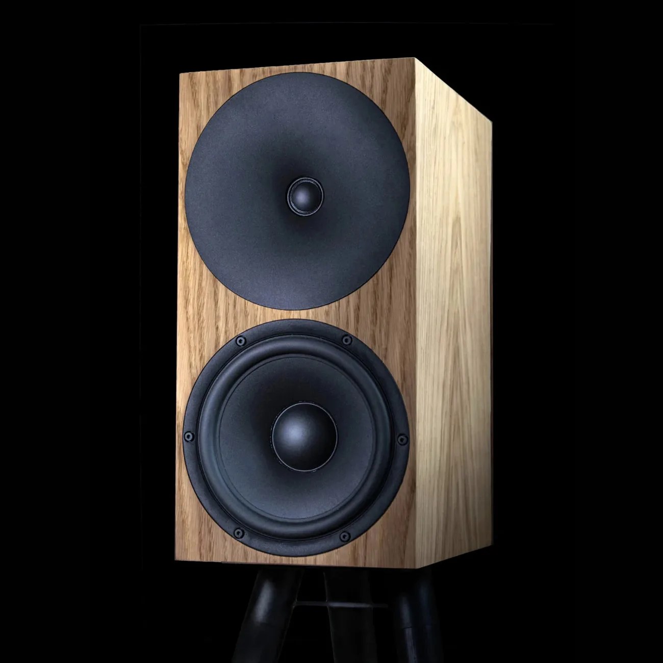 Wooden bookshelf speaker with black cone drivers on a black tripod stand.