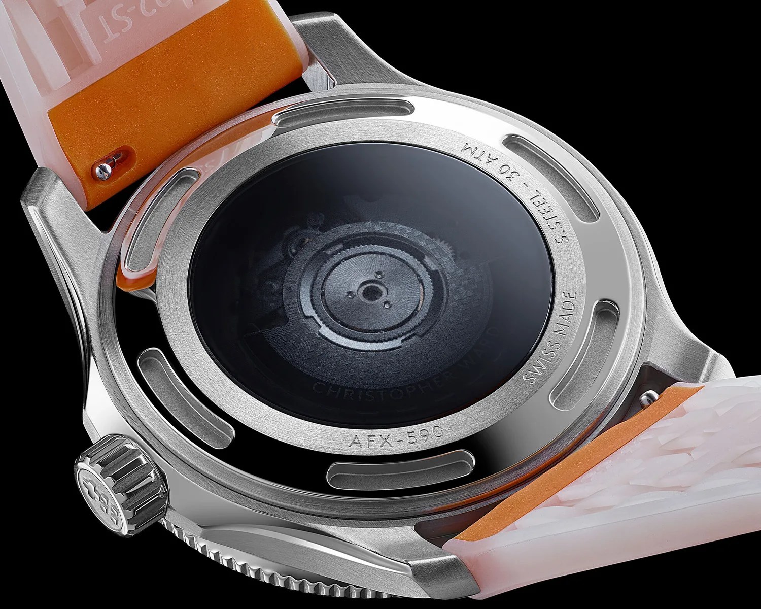 Close-up of a stainless steel watch back with visible mechanical movement and orange and translucent strap.