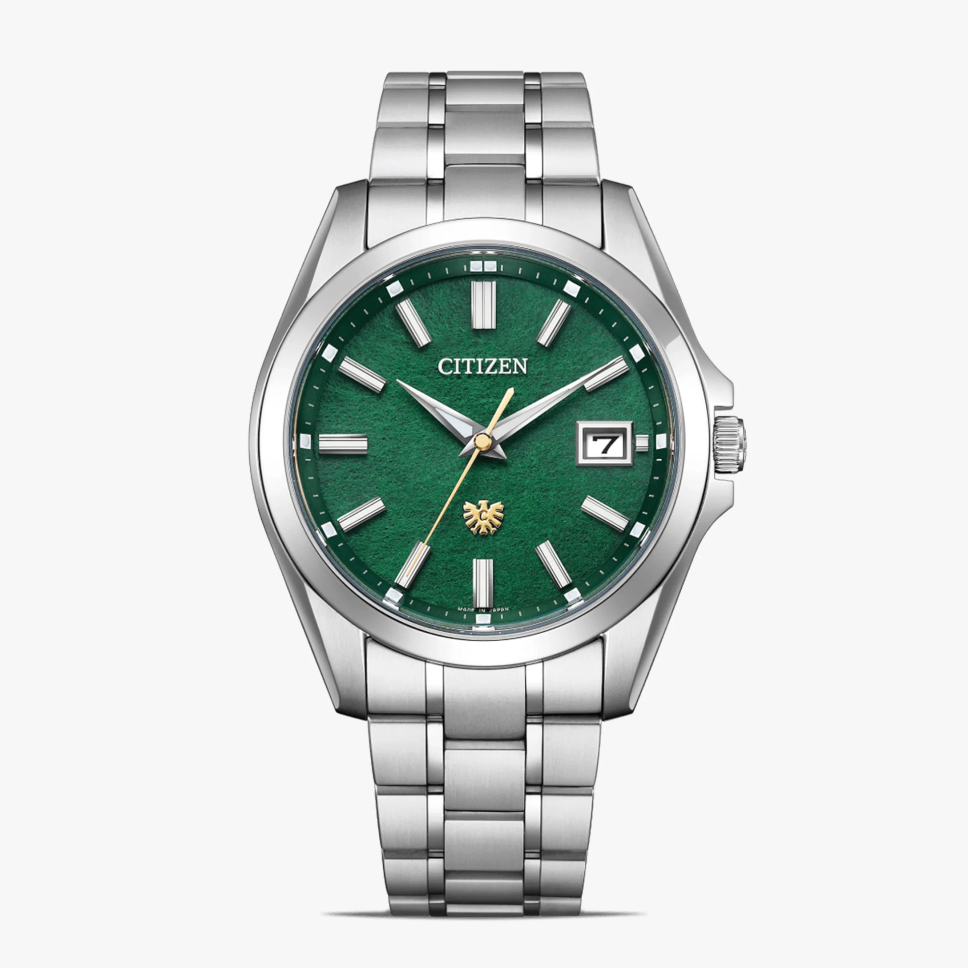 Silver titanium Citizen wristwatch with a textured green dial, date window, and gold emblem at 6 o'clock.