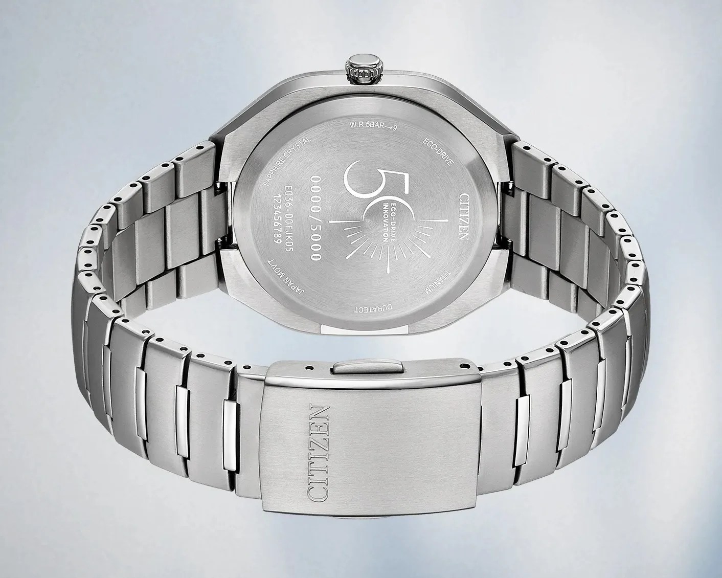 Brushed stainless steel Citizen watch band and case back with engraved text and clasp.