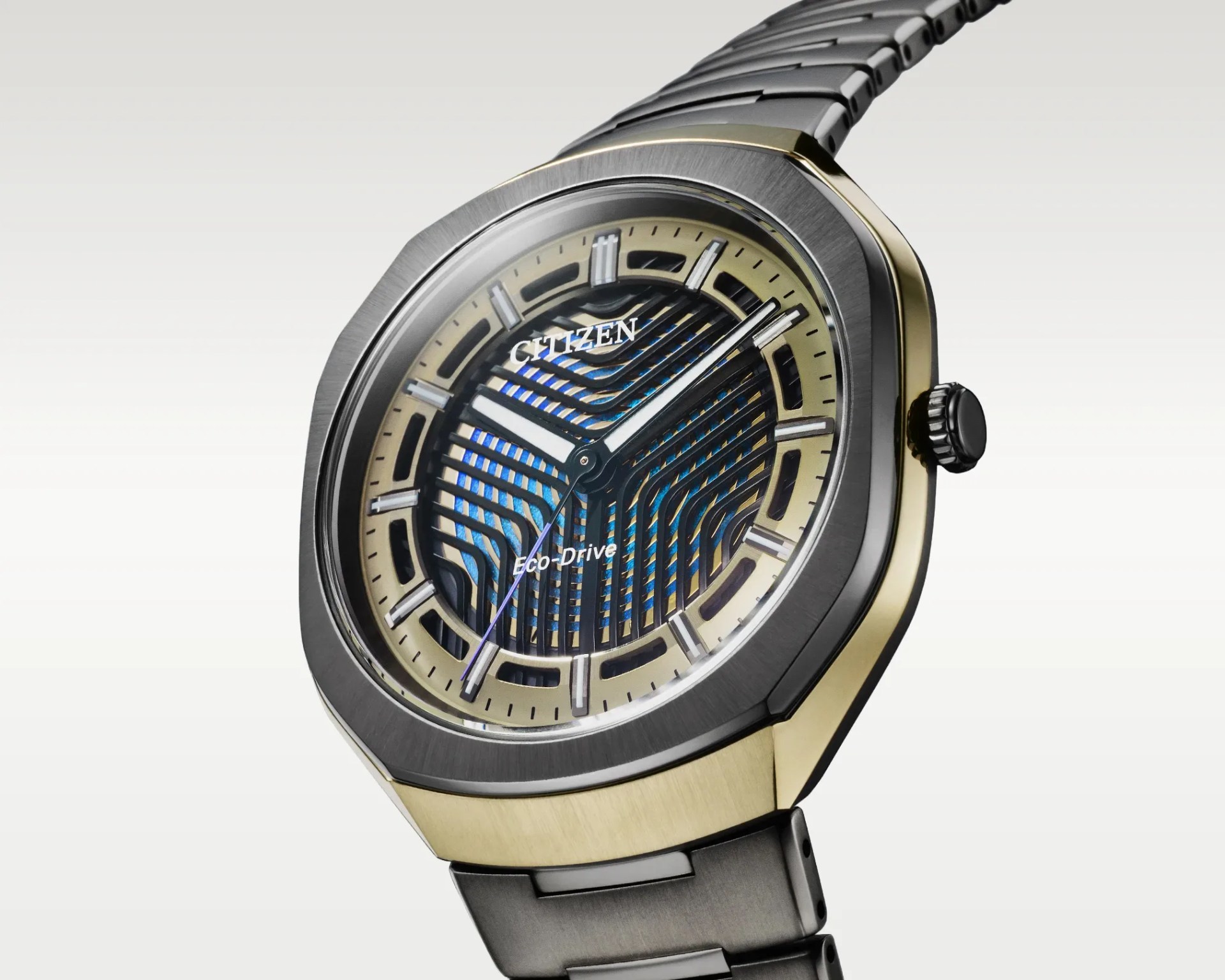 Citizen Eco-Drive wristwatch with a black and gold octagonal case and a patterned blue and black dial.