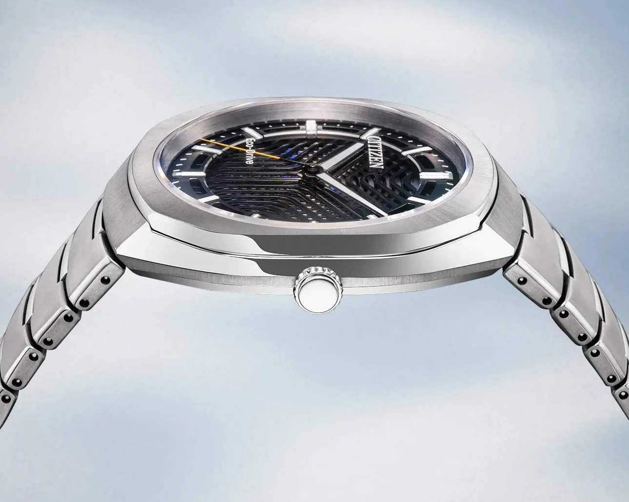 Silver stainless steel Citizen Eco-Drive wristwatch with black textured dial and yellow second hand.