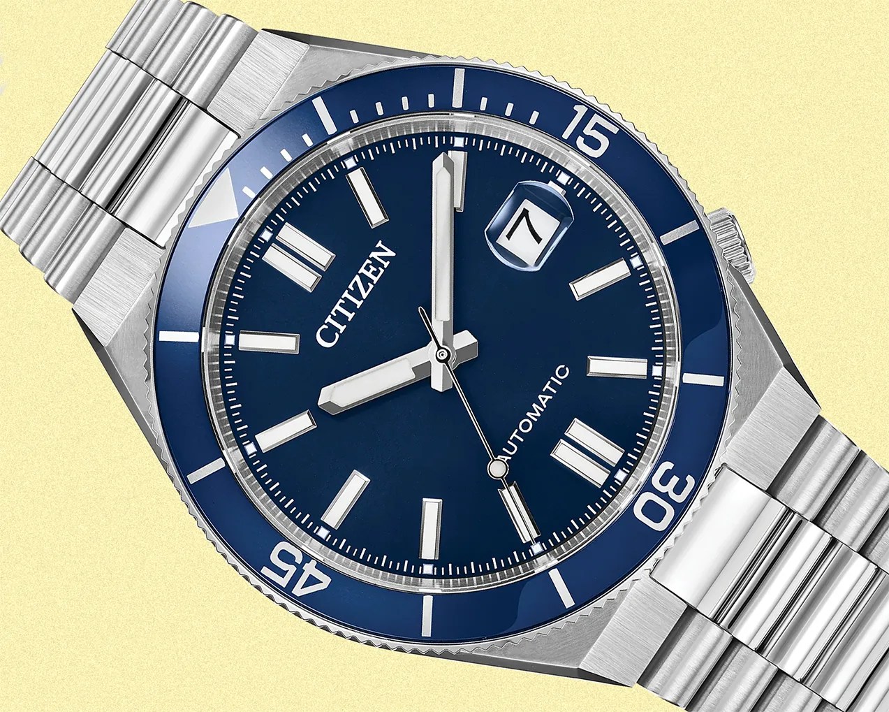 Stainless steel Citizen automatic wristwatch with a blue dial and bezel, silver hour markers, and date window at 3 o'clock.