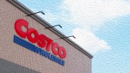 Costco Wholesale red and blue sign on a beige brick building under a partly cloudy sky.