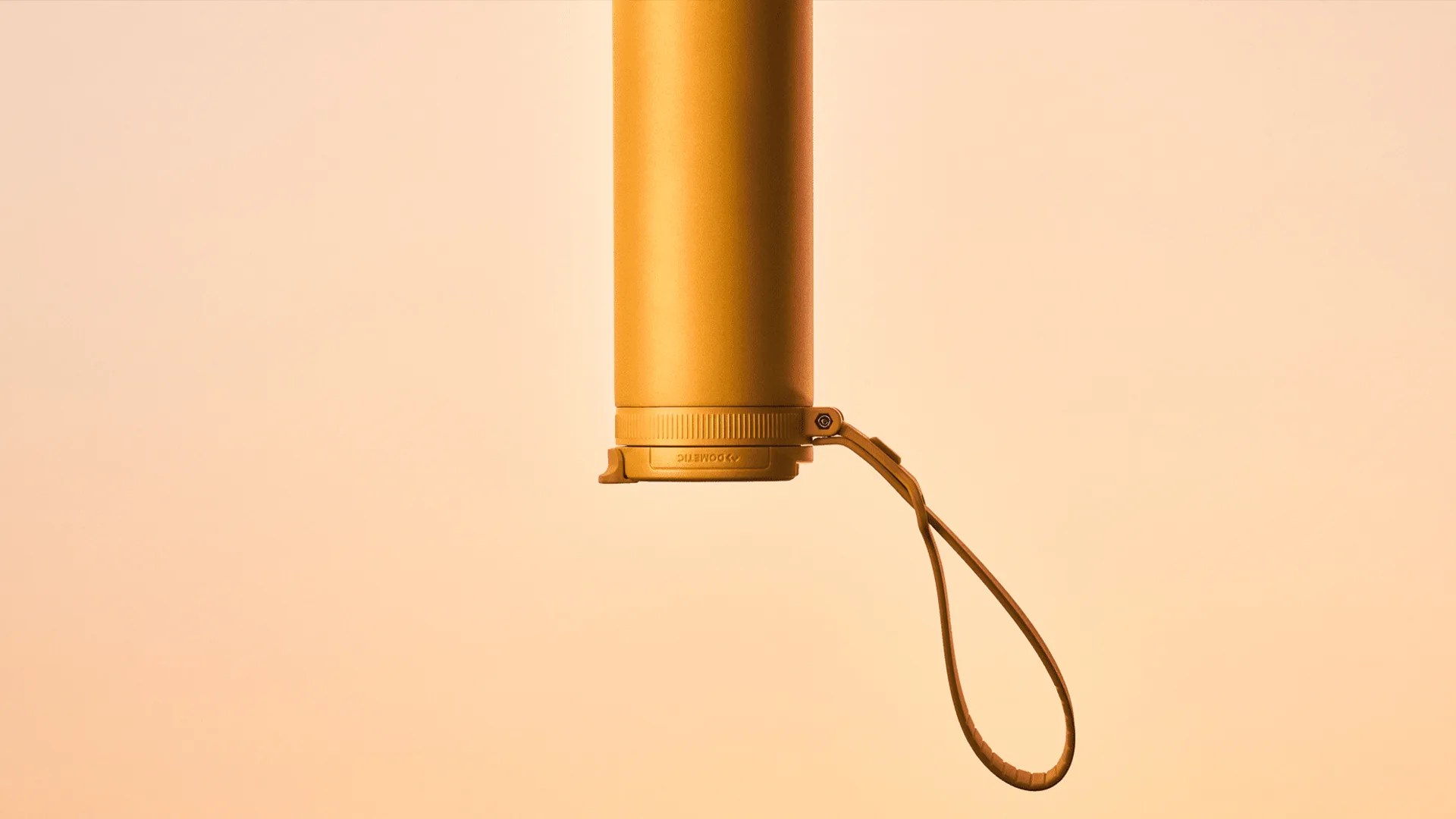 Matte orange cylindrical water bottle with a looped strap attached near the base.