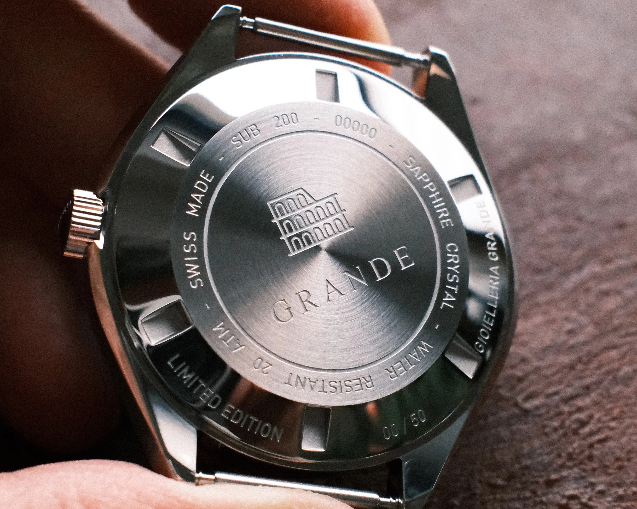 Close-up of a stainless steel watch back with engraved text including "GRANDE," "Swiss Made," "Sapphire Crystal," and "Limited Edition 00/50.