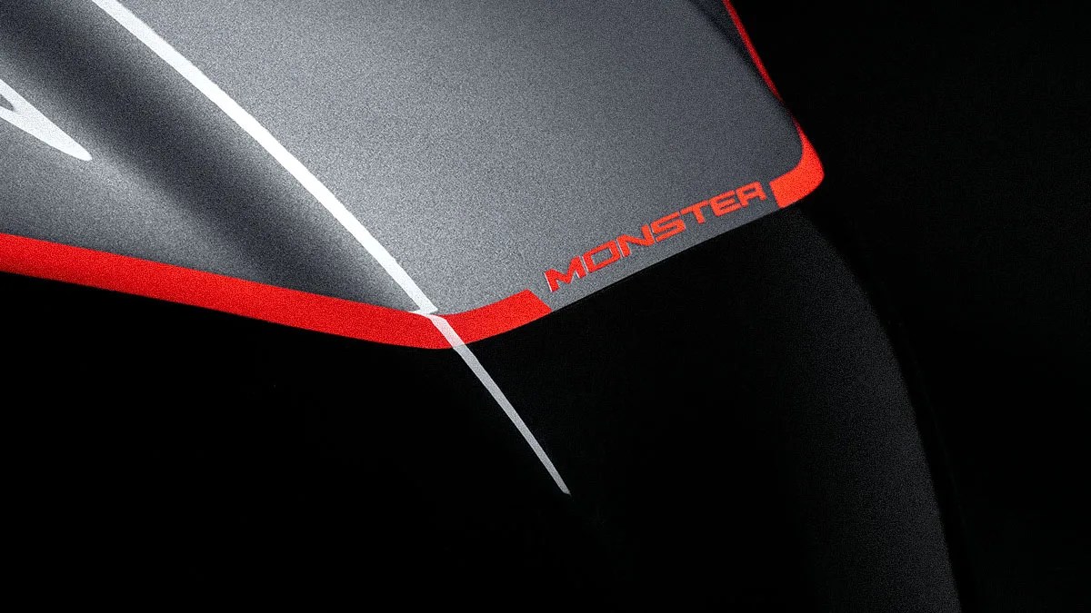 Close-up of a black and gray surface with red accents and the word "MONSTER" in red text.
