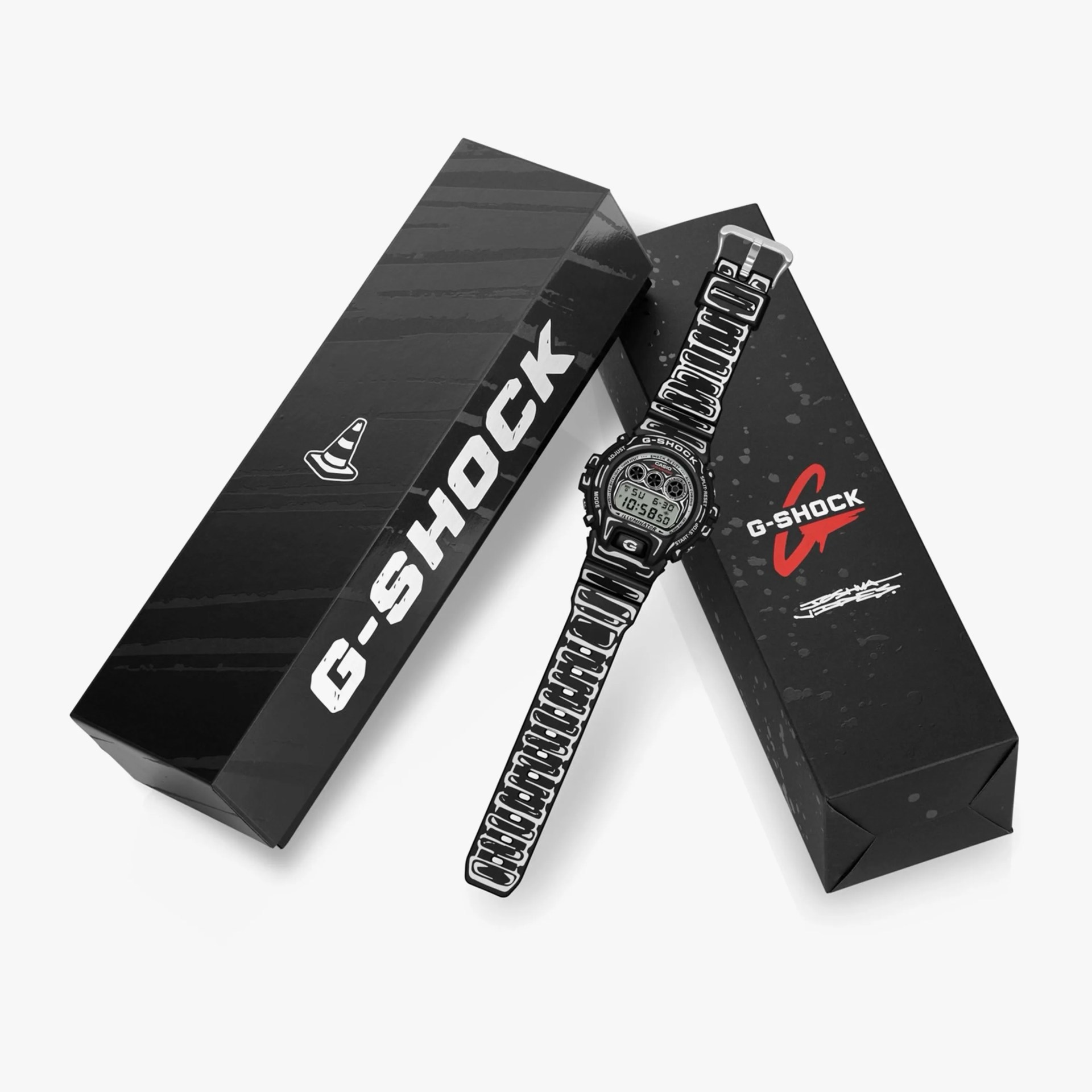 Black and white G-Shock digital watch with graphic strap and two black G-Shock branded boxes.