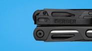 Close-up of a folded black Gerber multi-tool against a blue background.