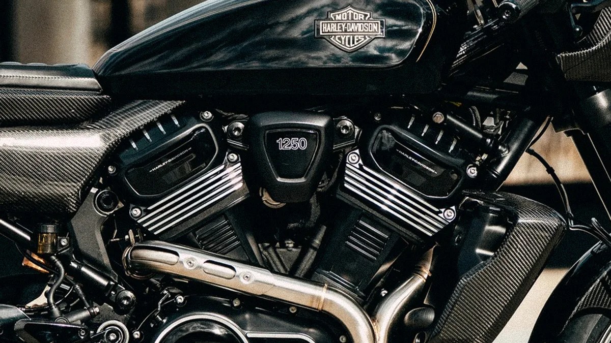 Close-up of a black Harley-Davidson motorcycle engine with "1250" marking and carbon fiber accents.