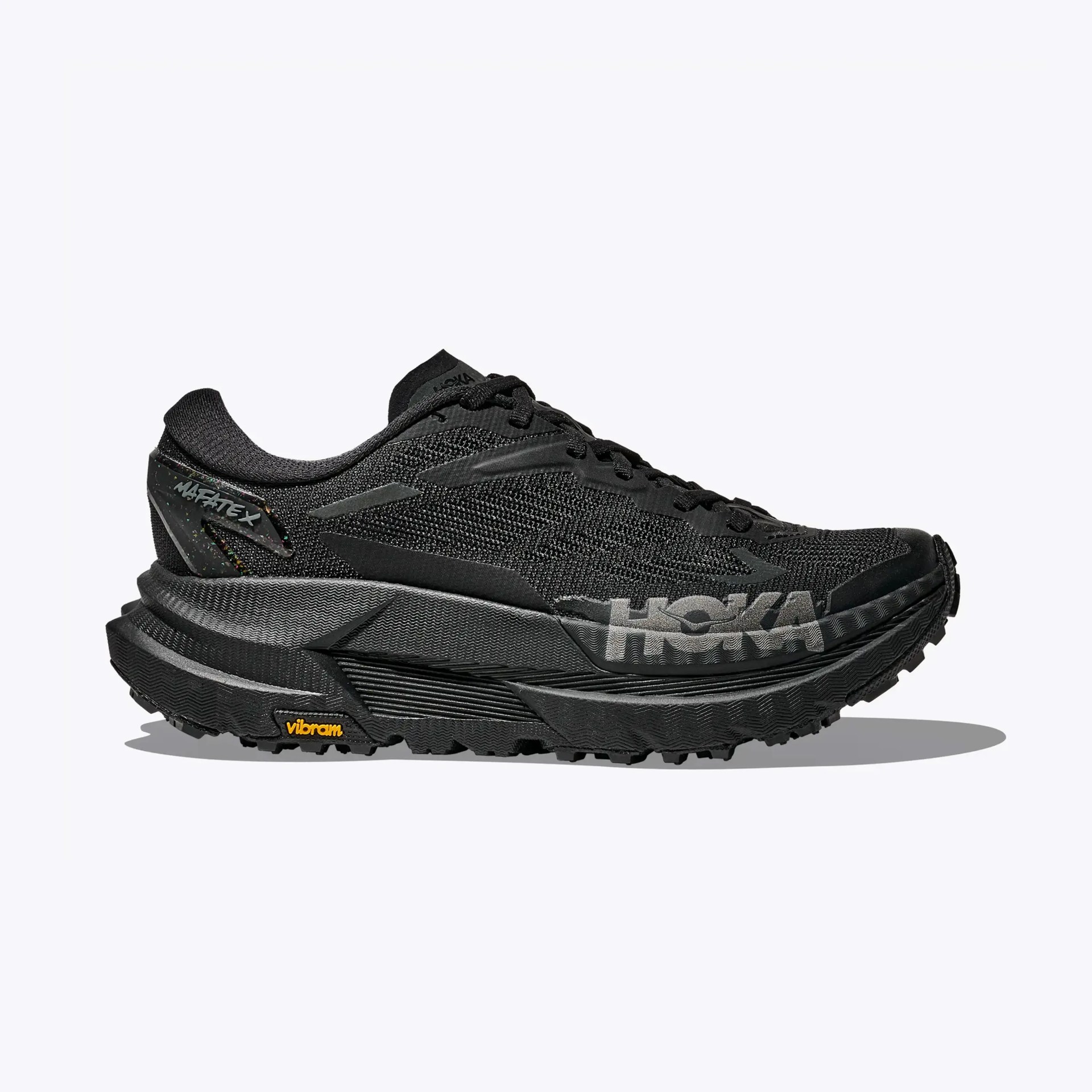 Black Hoka running shoe with thick sole, mesh upper, and Vibram outsole, shown in side profile.
