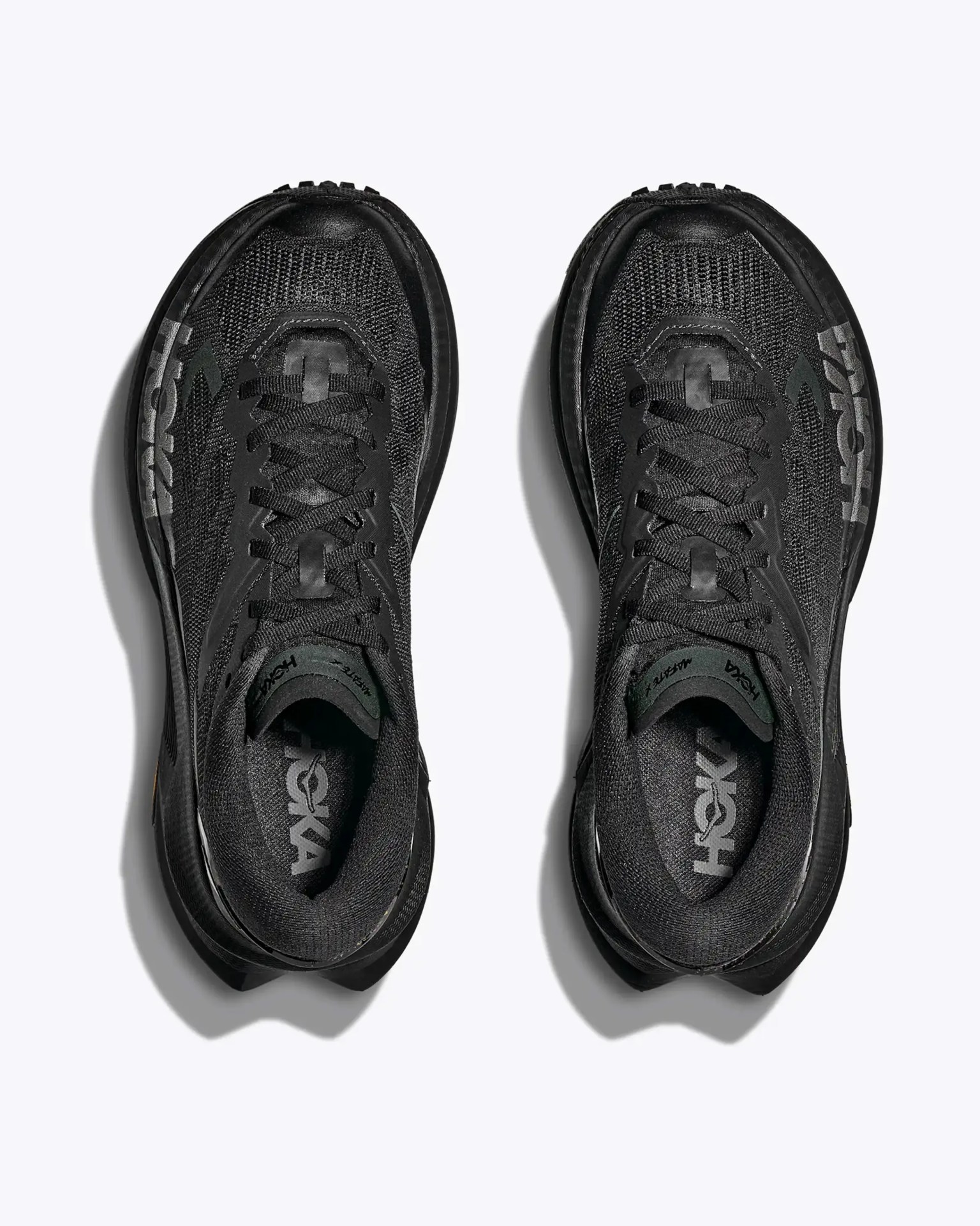 Pair of black Hoka running shoes with mesh uppers and large Hoka logo on the sides, viewed from above.