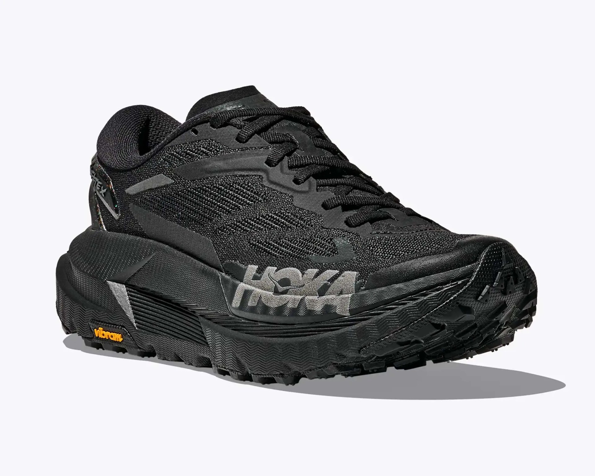Black Hoka running shoe with thick sole and Vibram logo on the heel.