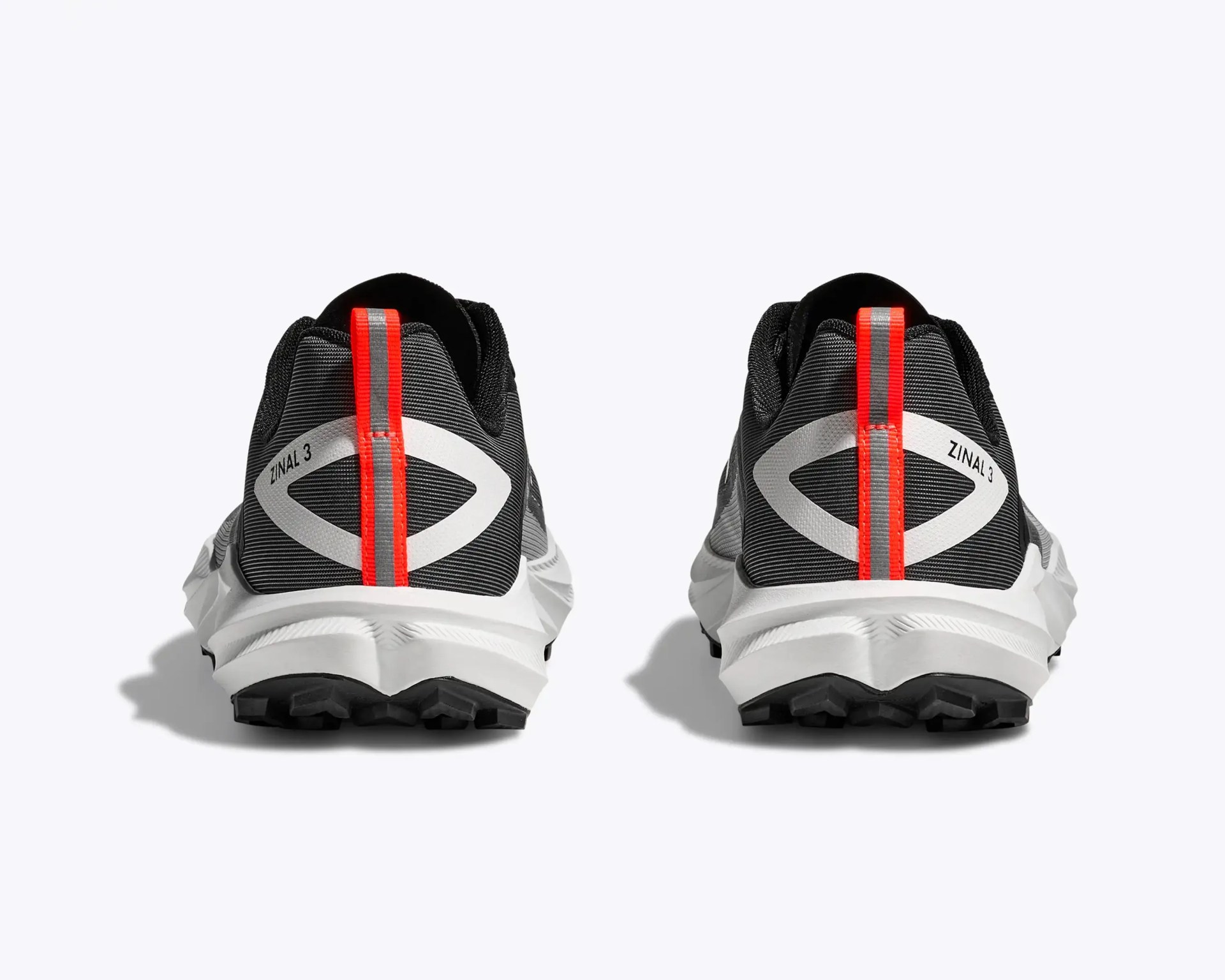 Pair of black and gray trail running shoes with white soles and red pull tabs, viewed from the back.