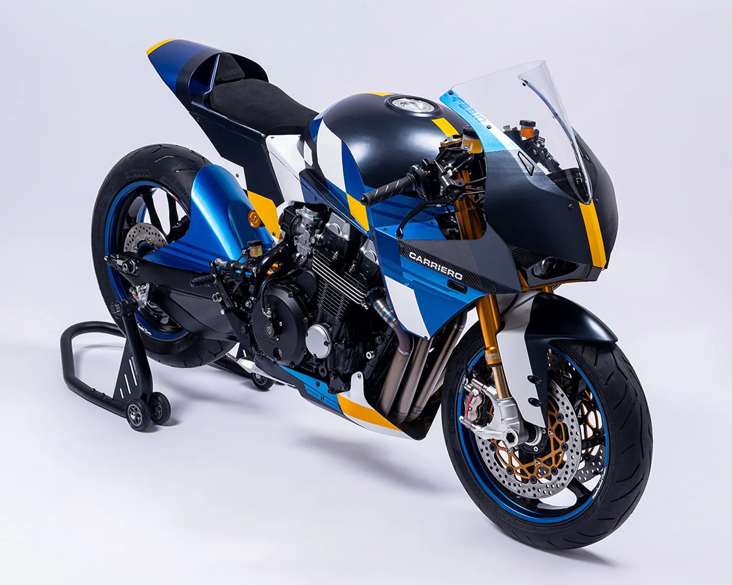 Blue, black, white, and yellow sport motorcycle with "Carriero" branding on a rear stand.