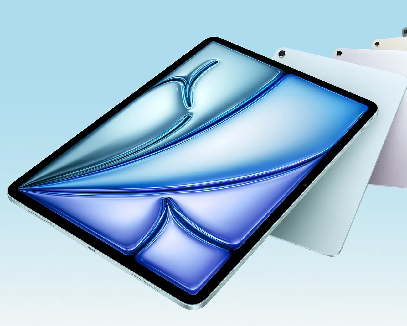 Four slim tablets in silver, white, pink, and beige with a blue abstract design on the front screen.