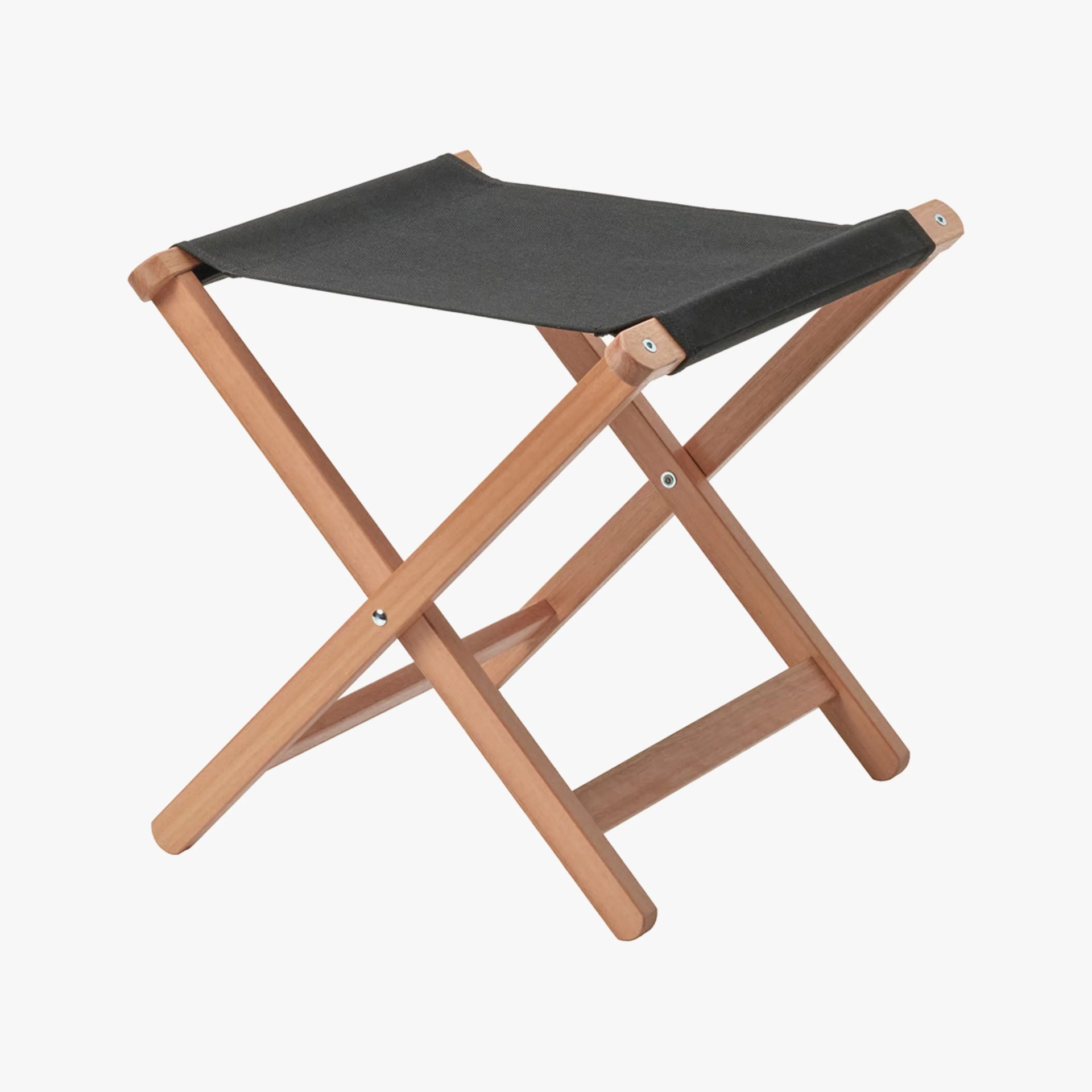 Folding wooden stool with black fabric seat and crossed legs.