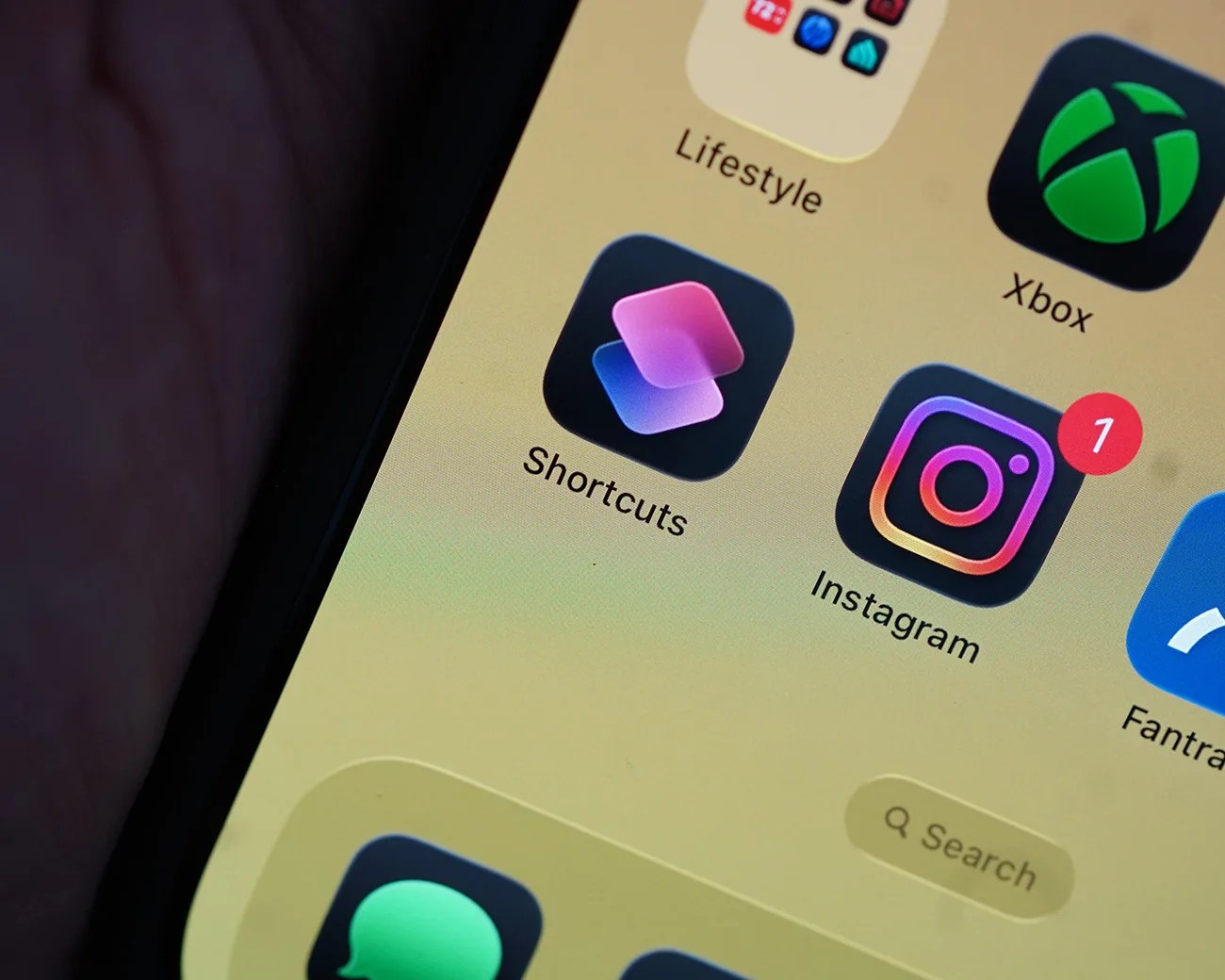Close-up of a smartphone screen showing Shortcuts and Instagram app icons with a notification badge on Instagram.