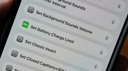 Smartphone screen showing settings options including "Set Background Sounds Volume," "Set Battery Charge Limit," "Set Classic Invert," and "Set Closed Captions+SDH.