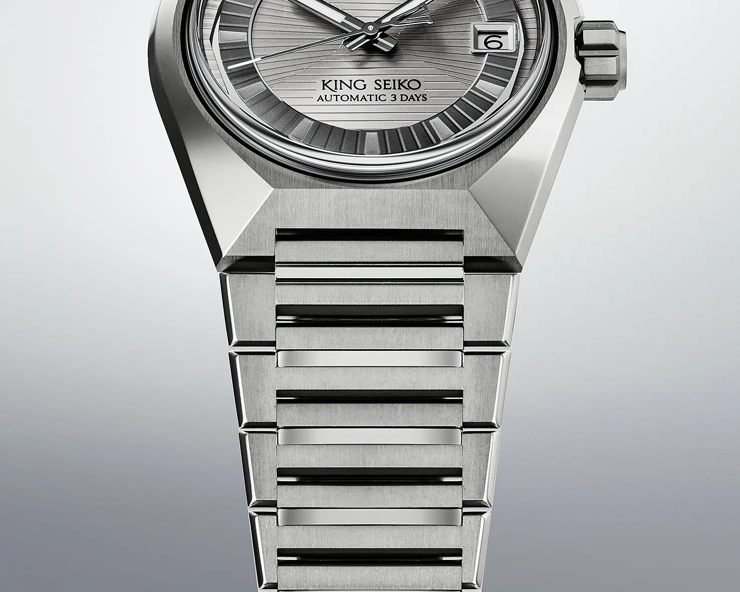 Close-up of a silver King Seiko automatic wristwatch with a textured dial and metal bracelet.