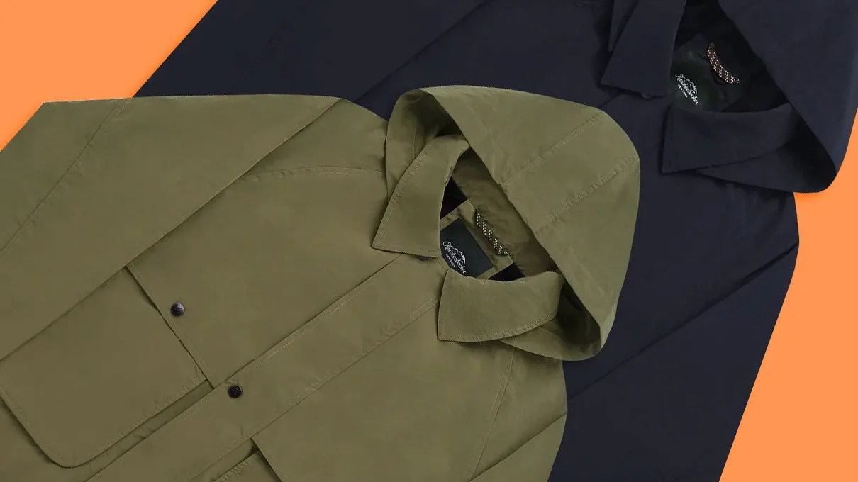 Olive green hooded jacket with front flap pockets layered over a navy hooded jacket on an orange and navy background.