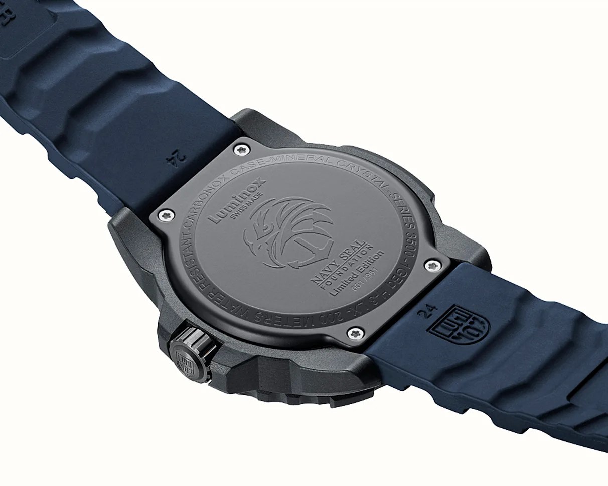 Back of a Luminox Navy SEAL Foundation limited edition watch with a black carbonox case and blue rubber strap.